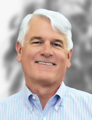 A portrait of Kevin O'Brien, a smiling man with gray hair wearing a striped shirt against a blurred background.