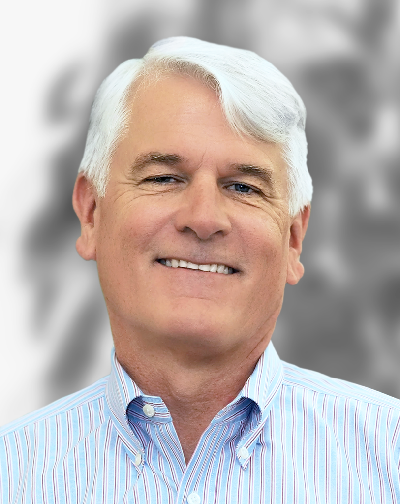 A portrait of Kevin O'Brien, a smiling man with gray hair wearing a striped shirt against a blurred background.