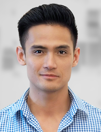 A portrait of Mark Martin, a man with short hair and a blue checked shirt against a blurred background.