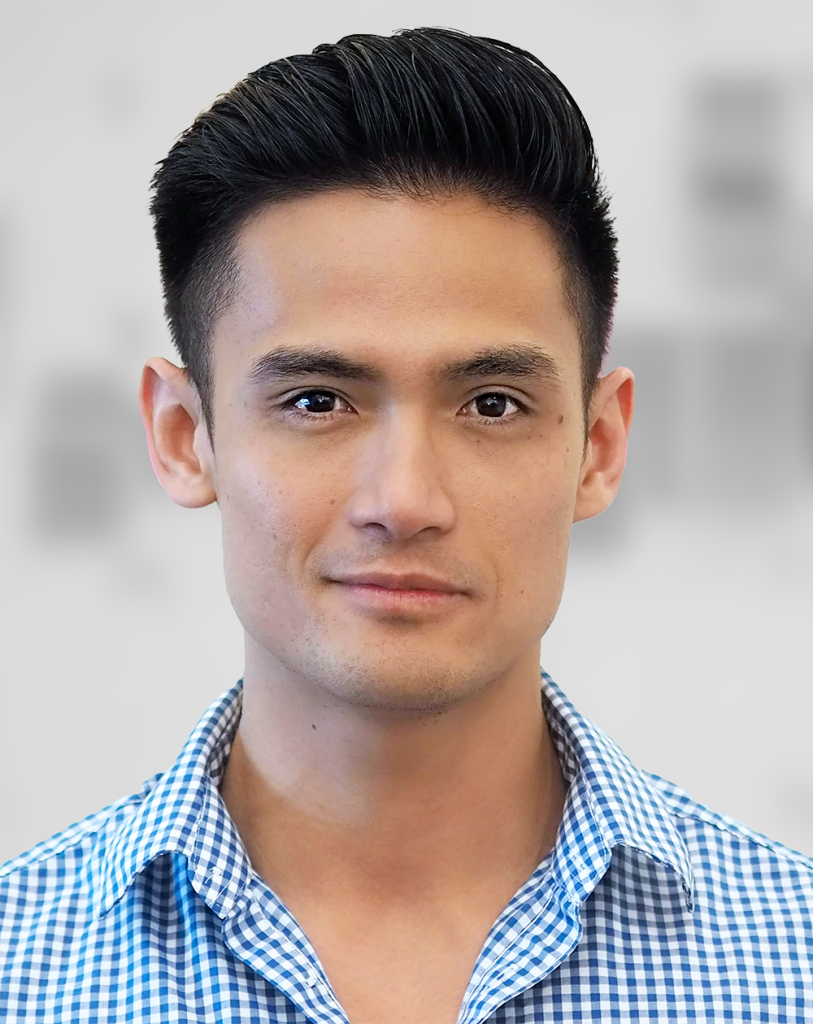 A portrait of Mark Martin, a man with short hair and a blue checked shirt against a blurred background.