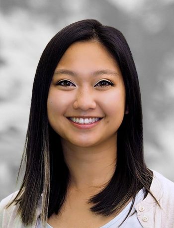 A portrait of Thu Nguyen, a smiling woman with shoulder-length dark hair against a blurred background.